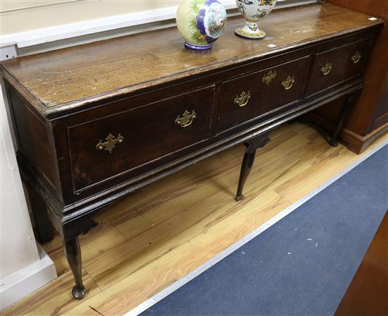 A mid 18th century oak dresser base, with three drawers on cabriole legs with pad feet, W.6ft D.1ft 4in. H.2ft 8in.